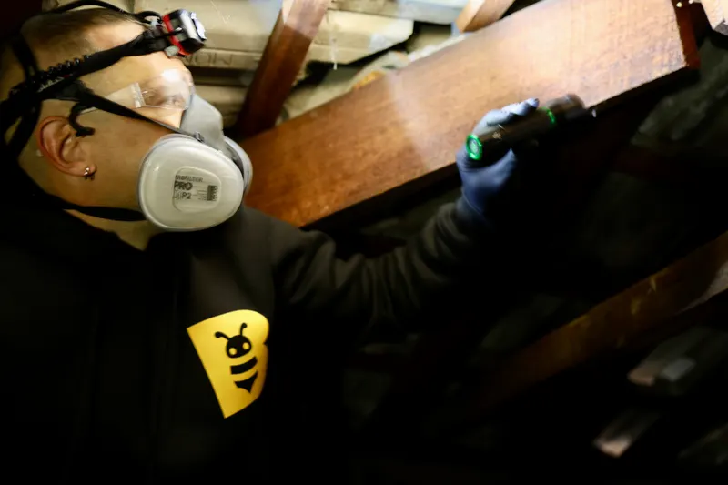 Fabien from FAB Pest Control carrying out precise termite treatment work on a structural area